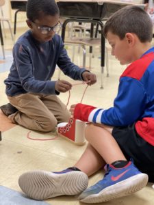 Students tying shoe