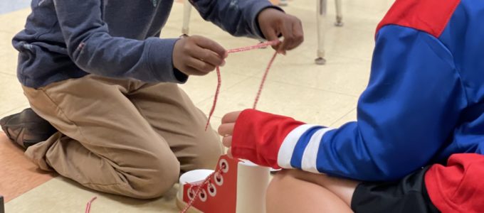 Students tying shoe