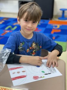 Boy drawing Johnny Appleseed