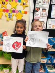 Two girls showing their work