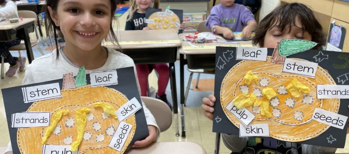 Students with Pumpkin Craft