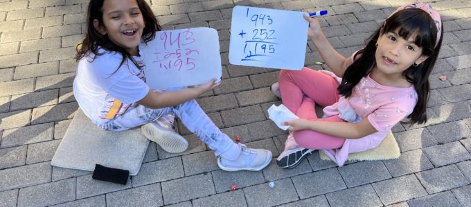 Girls doing math in the garden