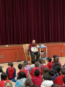 Mr. Bligh reading to students