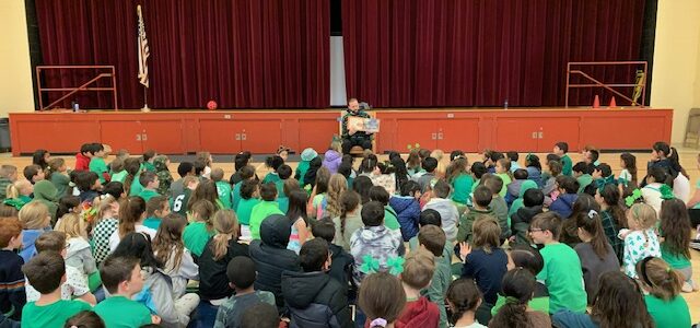 Mr. Bligh reading to students