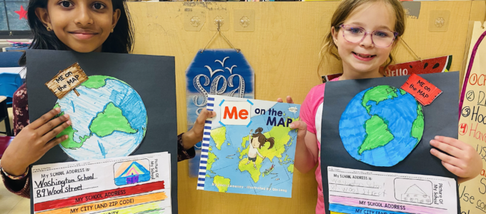 two students showing their maps