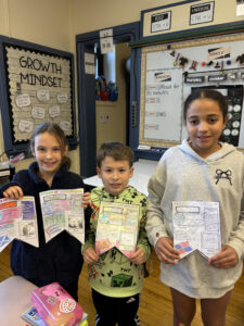 Three students showing their work