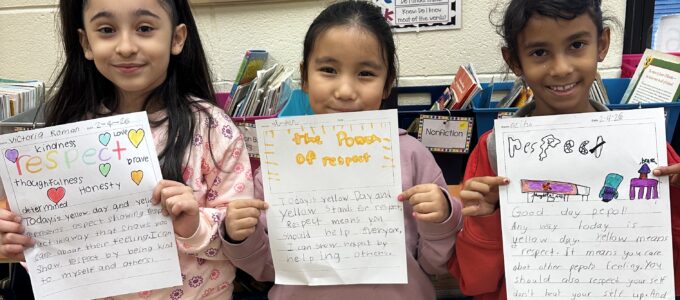 Three girls sharing their writing pieces