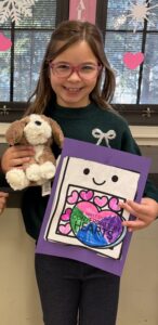 Girl with heart card and stuffed dog toy
