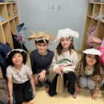 Two girls and two boys with hats