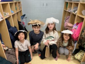 Two girls and two boys with hats