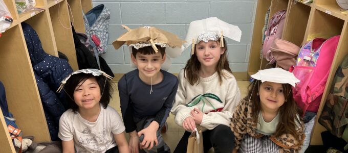Two girls and two boys with hats