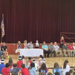 4 students reciting America's White Table