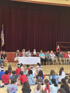 4 students reciting America's White Table