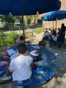 Students writing in the garden