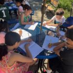 Students writing in the garden