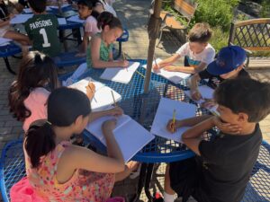 Students writing in the garden