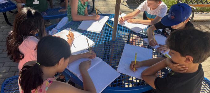 Students writing in the garden