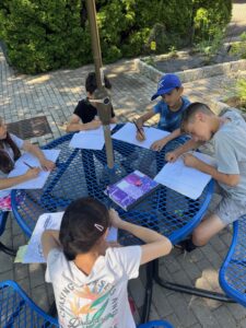 Students writing in the garden
