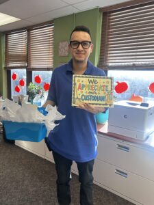 Mr. Sebastian holding up gifts