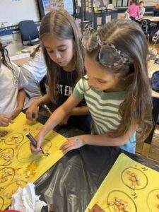 student scooping out pumpkin seeds