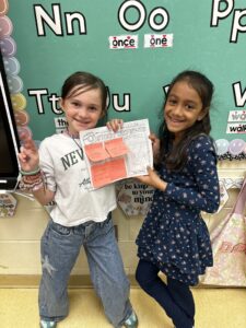Two girls with book
