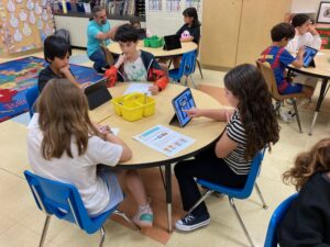 4 students around table working on creating a game