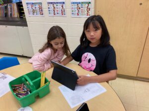 2 girls working on creating a game